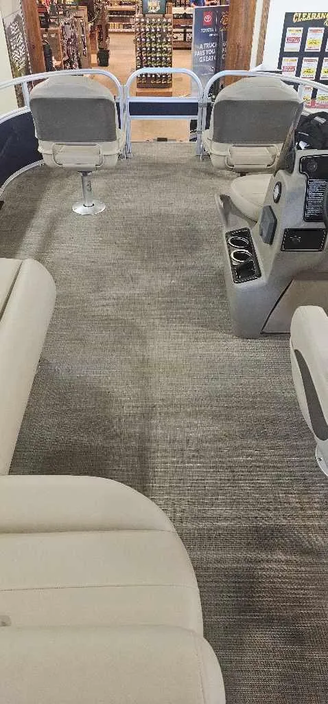 Slide: The Image of 2025 Sun Tracker Bass Buggy 16 XL Select interior with seating and console. - 3