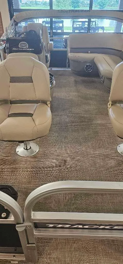 Slide: The Image of 2025 Sun Tracker Bass Buggy 16 XL Select interior with beige seating and carpeted floor. - 4