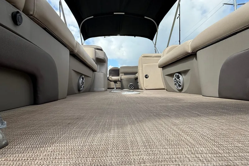 Slide: The Image of 2024 Sun Tracker SportFish 22 XP3 interior with beige seating and canopy. - 76