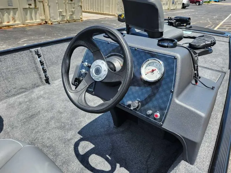 Slide: The Image of 2025 Tracker Bass Tracker Classic XL boat dashboard with steering wheel and gauges. - 3
