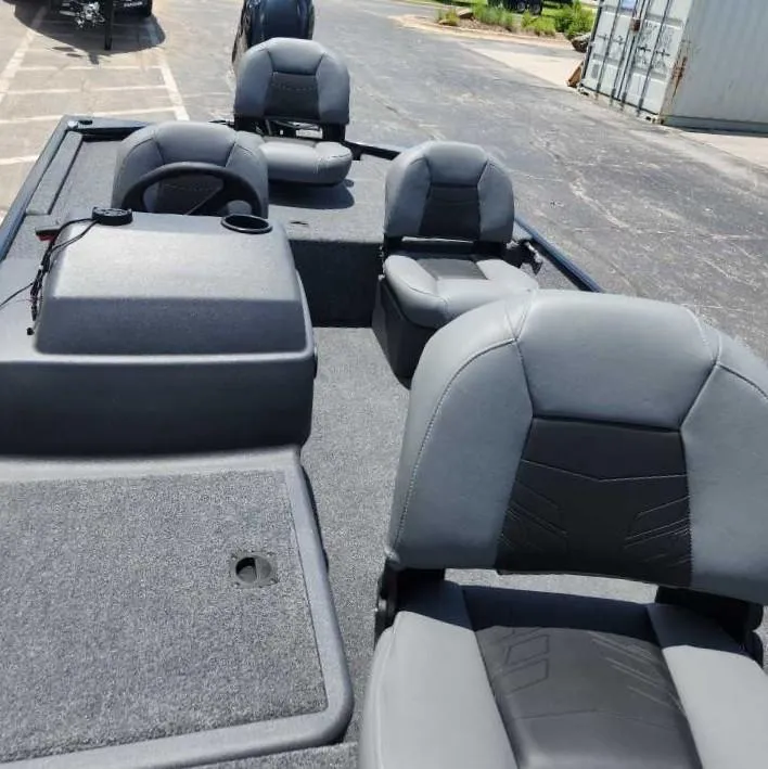Slide: The Image of 2025 Tracker Bass Tracker Classic XL boat interior with gray seating and carpeted deck. - 4