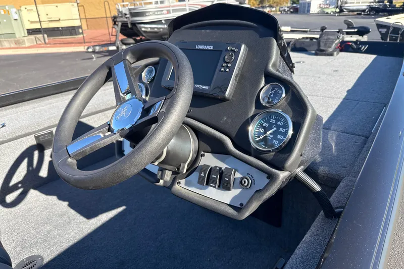 Slide: The Image of 2025 Ranger RT188C boat dashboard with steering wheel and gauges. - 7