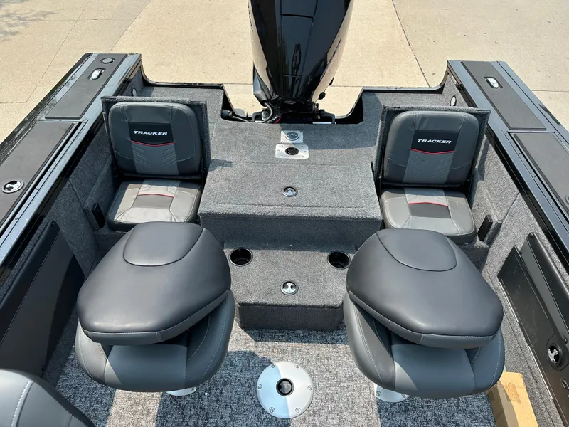 Slide: The Image of 2025 Tracker Targa V-19 Combo boat interior with two seats and storage compartments. - 10