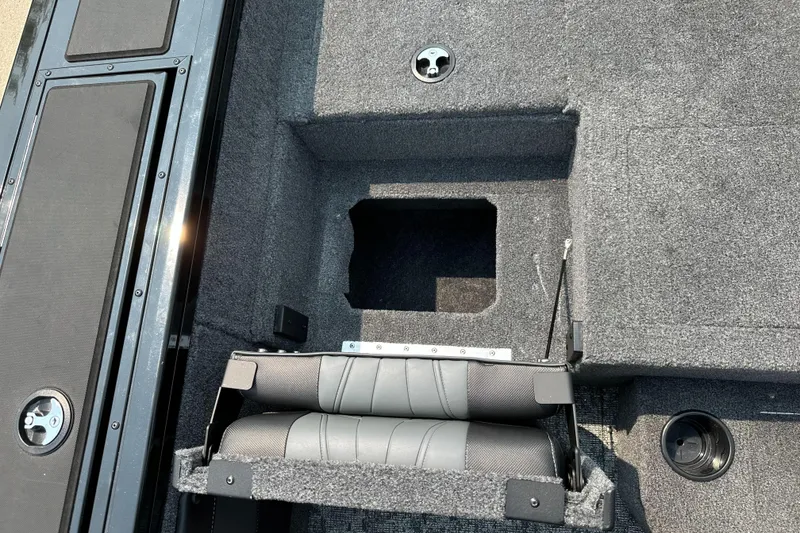 Slide: The Image of 2025 Tracker Targa V-19 Combo boat interior with storage compartment and seating. - 11