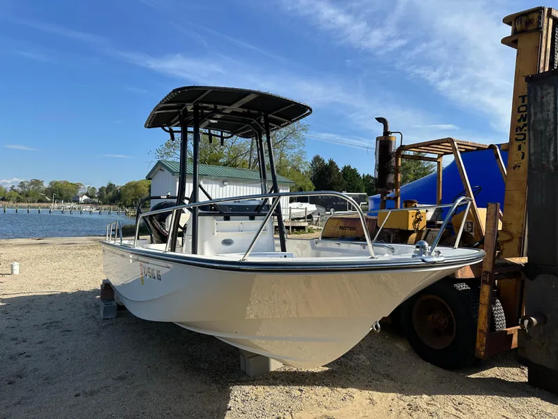 Slide: The Image of 2024 Boston Whaler 190 Montauk boat on shore, featuring a sleek design and sturdy build. - 2