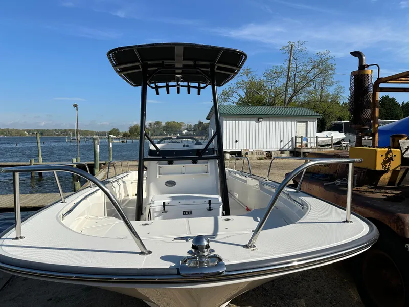 Slide: The Image of 2024 Boston Whaler 190 Montauk boat docked by a serene lakeside. - 4