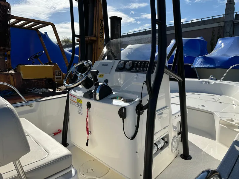 Slide: The Image of 2024 Boston Whaler 190 Montauk boat interior with steering console and seating. - 6