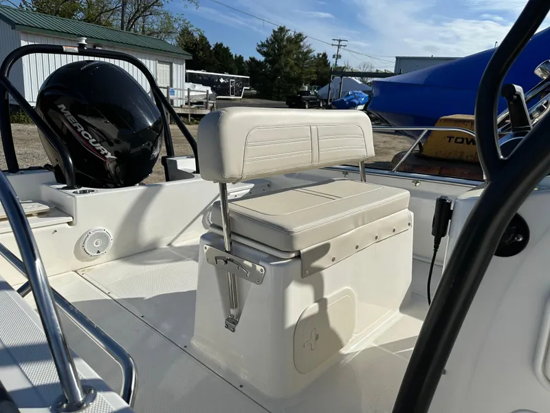Slide: The Image of 2024 Boston Whaler 190 Montauk boat interior with seating and Mercury engine. - 7