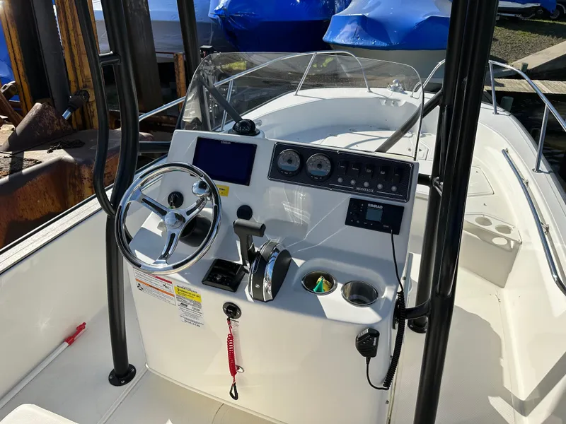 Slide: The Image of 2024 Boston Whaler 190 Montauk boat dashboard with steering wheel and controls. - 9