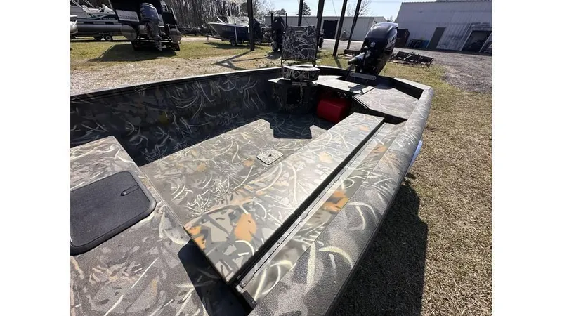 Slide: The Image of 2025 War Eagle 750 Gladiator boat with camouflage design, parked outdoors. - 4