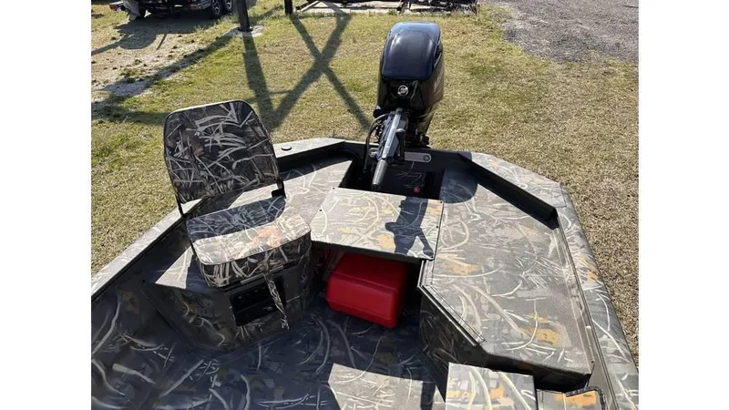 Slide: The Image of 2025 War Eagle 750 Gladiator boat with camouflage seating and outboard motor. - 5