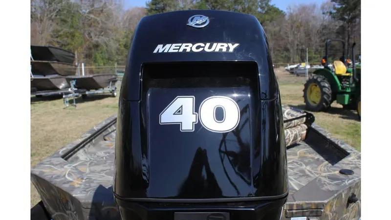 Slide: The Image of 2025 War Eagle 750 Gladiator with Mercury 40 outboard motor in a rural setting. - 8