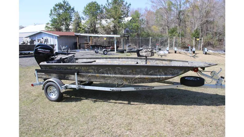Slide: The Image of 2025 War Eagle 750 Gladiator boat on trailer, parked outdoors. - 9