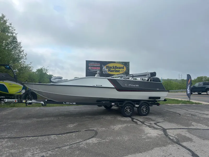 Slide: The Image of 2025 Lowe Deck SD224 boat on trailer at BlackBeard Marine dealership. - 0