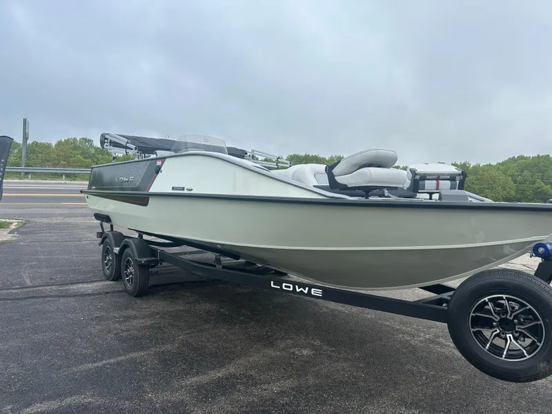 Slide: The Image of 2025 Lowe Deck SD224 boat on trailer, parked outdoors. - 3
