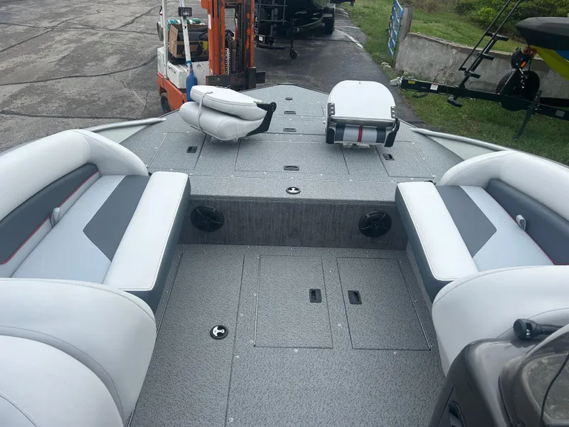 Slide: The Image of 2025 Lowe Deck SD224 boat interior with gray seating and storage compartments. - 6