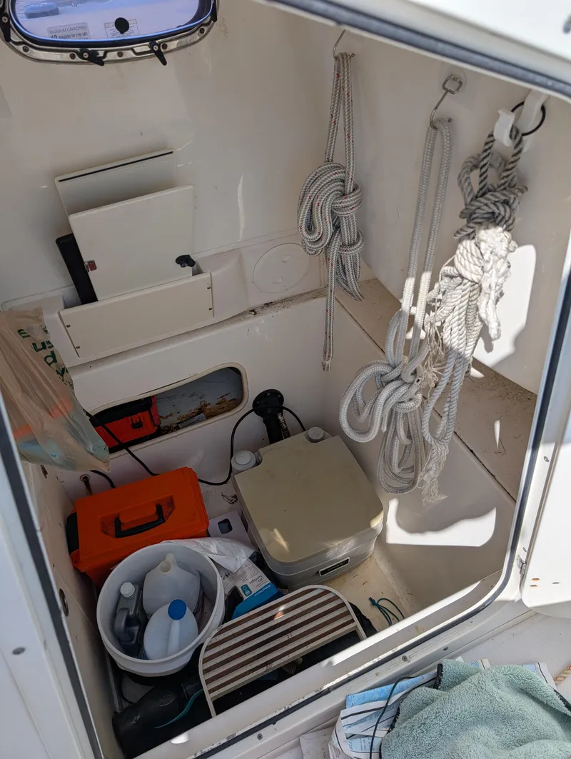 Slide: The Image of Interior of 2008 Boston Whaler 24 Outrage with ropes, storage, and equipment. - 23