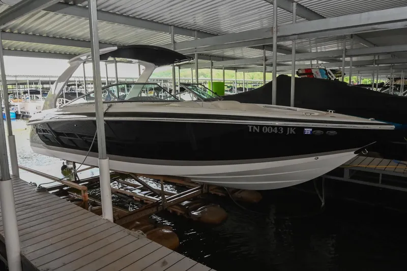 The Image of 2005 Cobalt 262 boat docked in a covered marina. - 0
