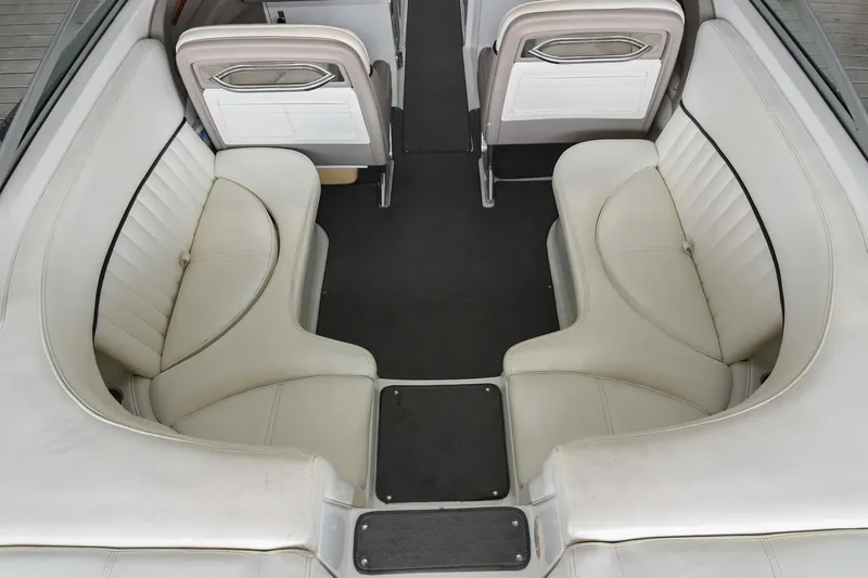 Slide: The Image of 2005 Cobalt 262 boat interior with white leather seating and sleek design. - 11