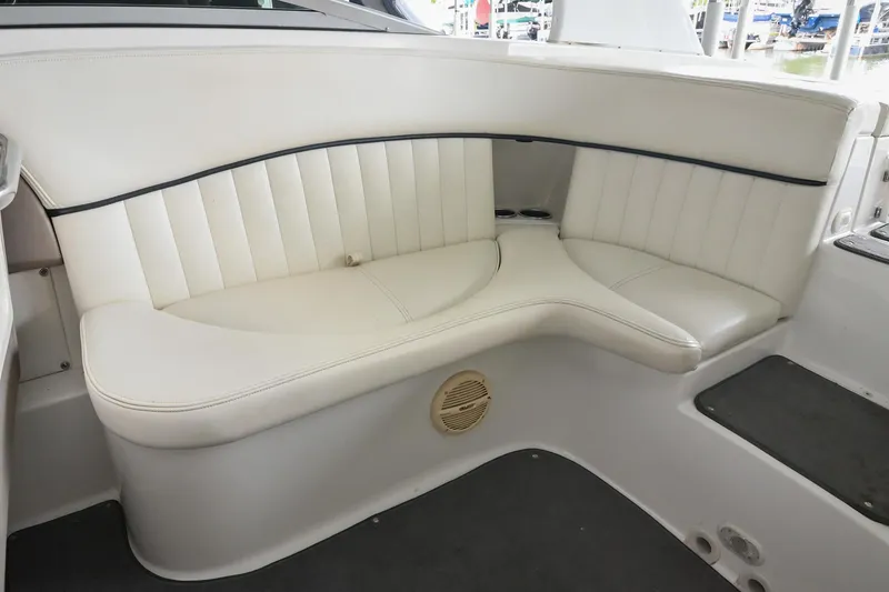 Slide: The Image of 2005 Cobalt 262 boat interior with white leather seating and speaker. - 13
