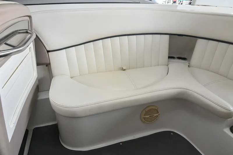 Slide: The Image of 2005 Cobalt 262 boat interior with white leather seating and speaker. - 14