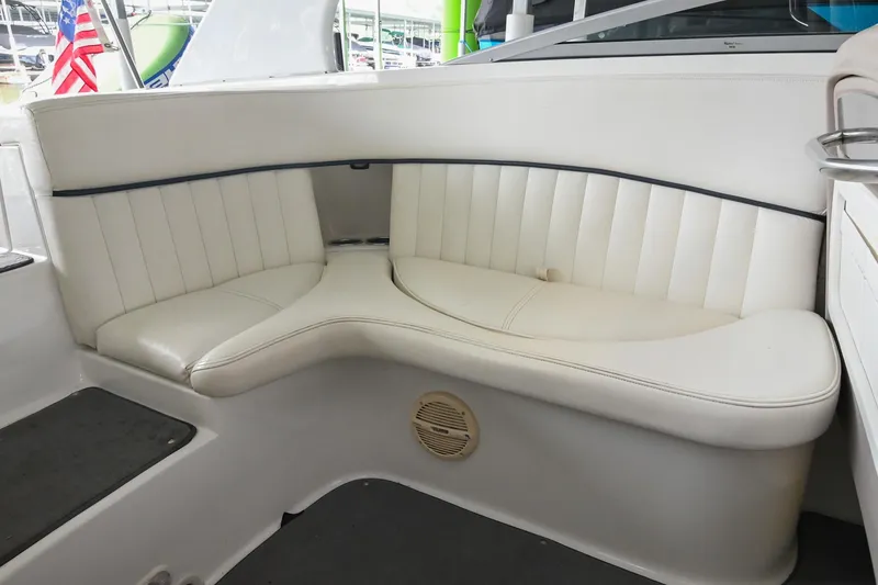 Slide: The Image of 2005 Cobalt 262 boat interior with white leather seating and speaker. - 16