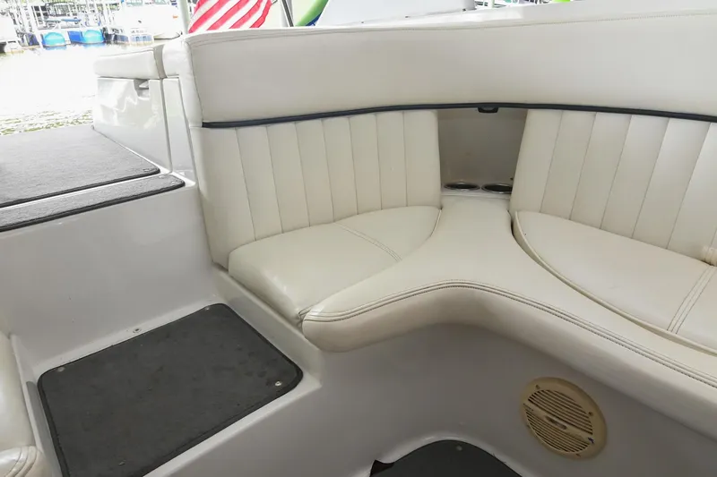 Slide: The Image of 2005 Cobalt 262 boat interior with white cushioned seating and speaker. - 18