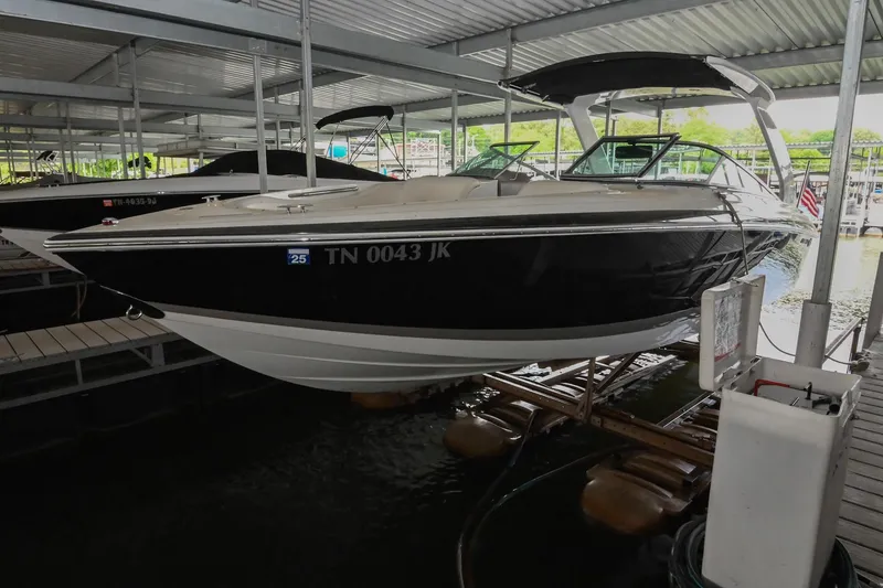 Slide: The Image of 2005 Cobalt 262 boat docked in a covered marina. - 2