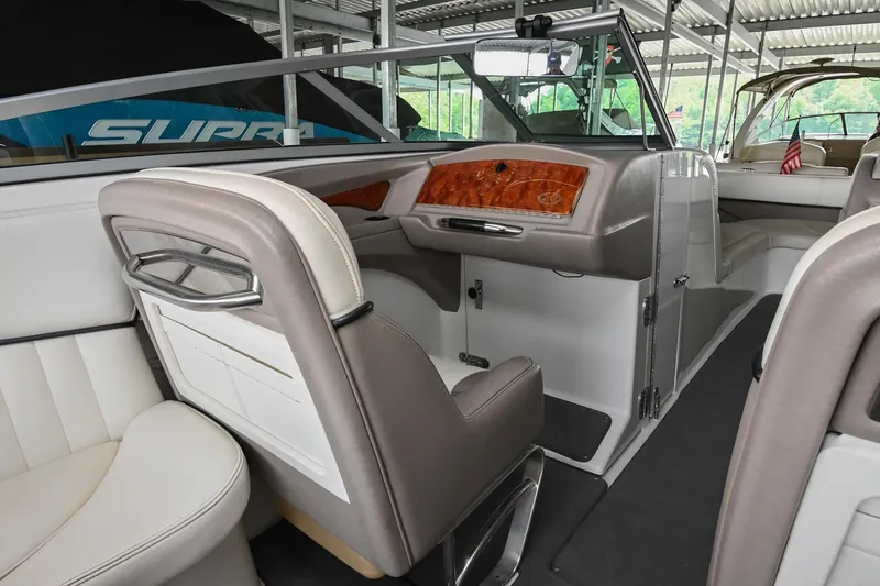 Slide: The Image of Interior of a 2005 Cobalt 262 boat with luxurious seating and wood accents. - 21