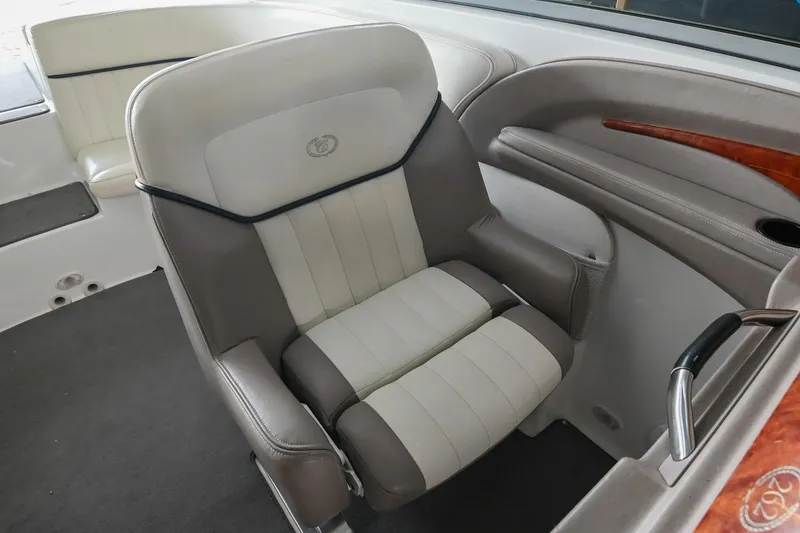 Slide: The Image of Captain's chair in 2005 Cobalt 262 boat, featuring beige and gray upholstery. - 24