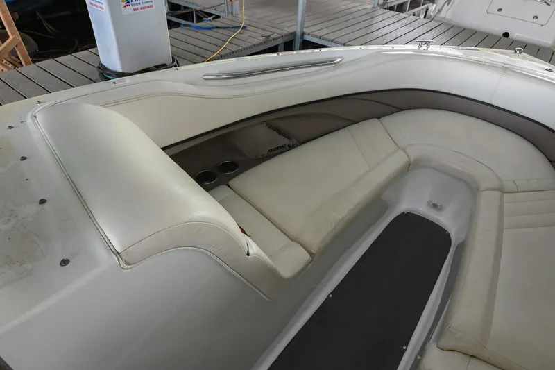 Slide: The Image of 2005 Cobalt 262 boat interior with white leather seating and cup holders. - 33