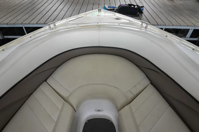 Slide: The Image of 2005 Cobalt 262 boat interior with cream leather seating at dock. - 37