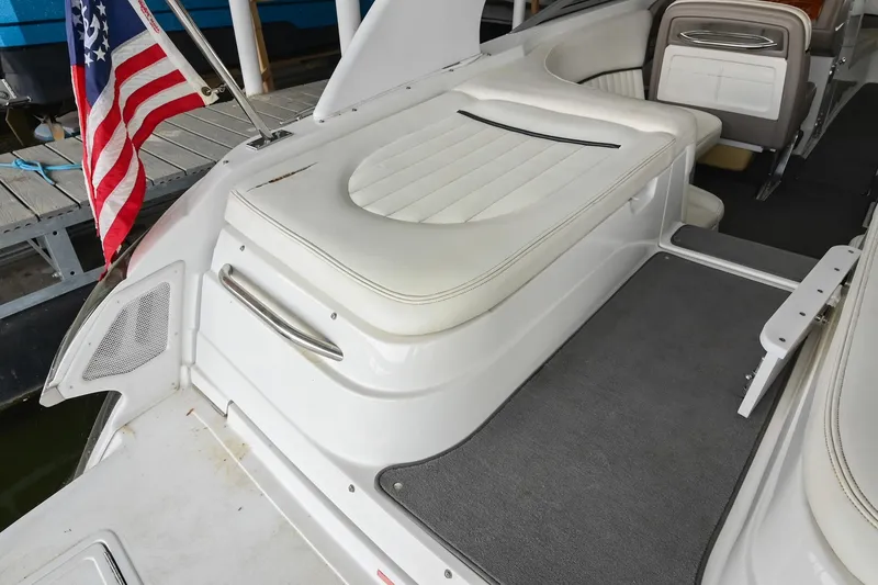 Slide: The Image of 2005 Cobalt 262 boat interior with white seating and American flag. - 8