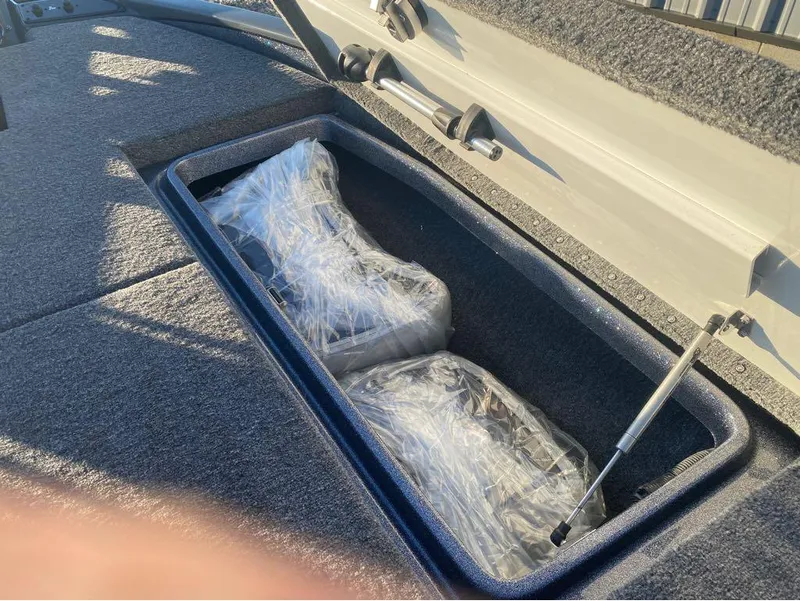 Slide: The Image of Storage compartment of 2025 Phoenix 920 Elite boat with wrapped items inside. - 13