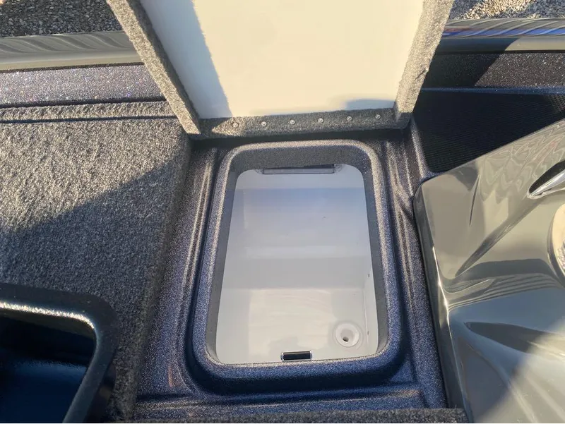 Slide: The Image of Open storage compartment in 2025 Phoenix 920 Elite boat, featuring a sleek interior design. - 14
