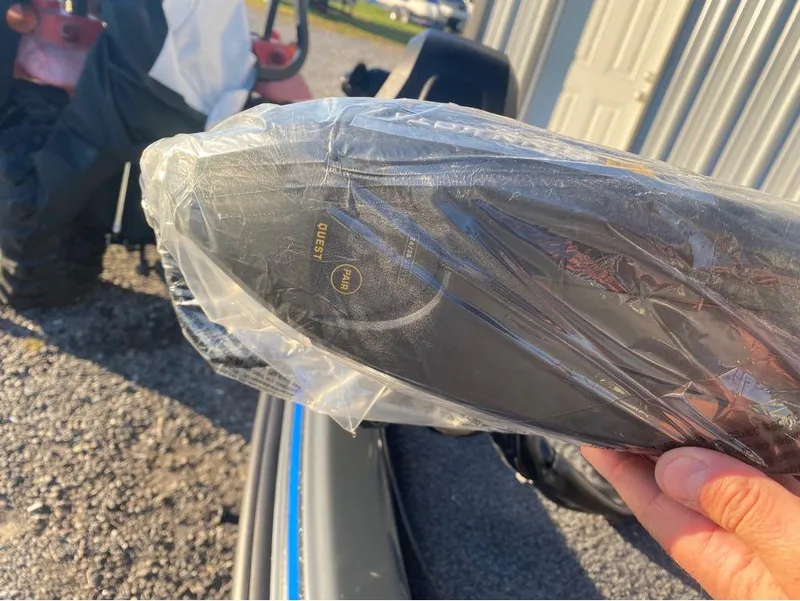 Slide: The Image of Plastic-wrapped Phoenix 920 Elite part, 2025 model, held outdoors near a tractor. - 18