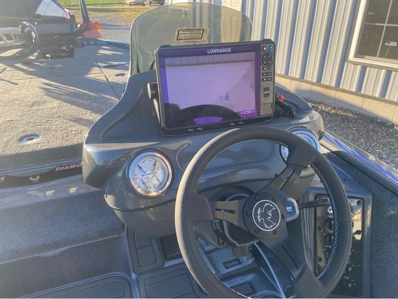 Slide: The Image of Steering console of 2025 Phoenix 920 Elite boat with Lowrance display and gauges. - 2