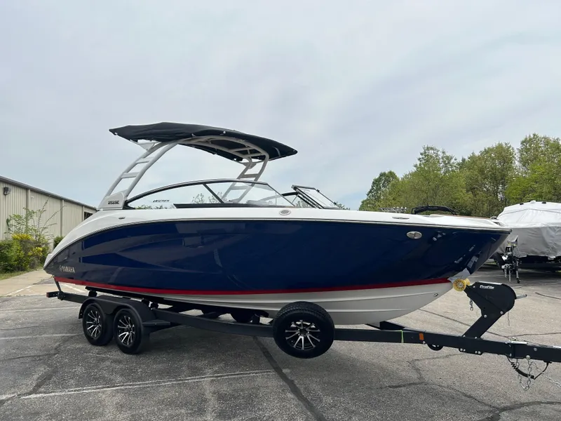 Slide: The Image of 2025 Yamaha Boats 252SE on trailer, sleek design, blue hull, outdoor setting. - 5