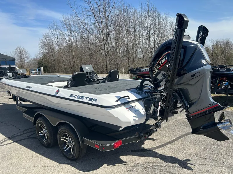 Slide: The Image of 2025 Skeeter ZXR21 boat with powerful outboard motor, parked on a trailer. - 2