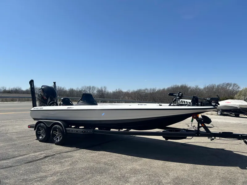Slide: The Image of 2025 Skeeter ZXR21 boat on trailer in parking lot, clear sky background. - 3