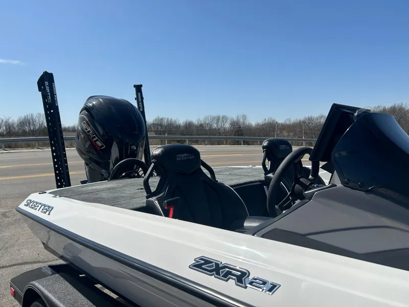 Slide: The Image of 2025 Skeeter ZXR21 boat with dual seats and powerful outboard motor. - 4