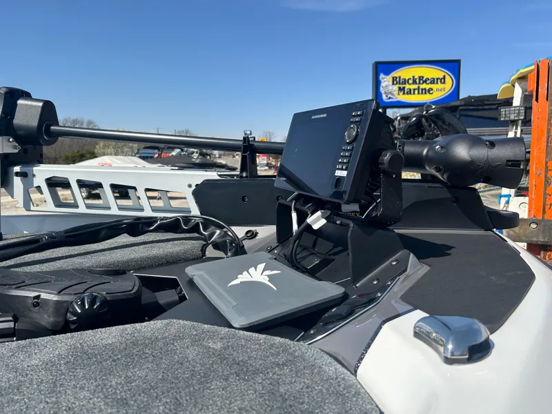 Slide: The Image of 2025 Skeeter ZXR21 boat dashboard with electronics, BlackBeard Marine sign in background. - 5