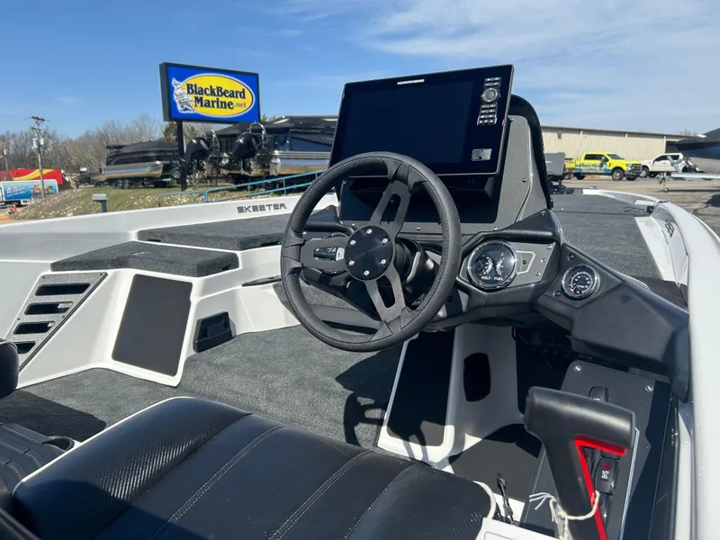 Slide: The Image of 2025 Skeeter ZXR21 boat interior with steering wheel and dashboard at Blackbeard Marine. - 6