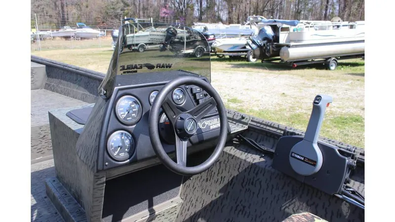 Slide: The Image of 2025 War Eagle 860LDSV Sportsman boat dashboard with steering wheel and control panel. - 7