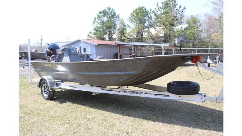 Slide: The Image of 2025 War Eagle 860LDSV Sportsman boat on trailer, outdoors near trees and building. - 9