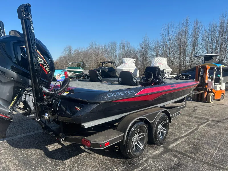 Slide: The Image of 2025 Skeeter ZXR21 boat with dual axle trailer in a parking lot. - 3