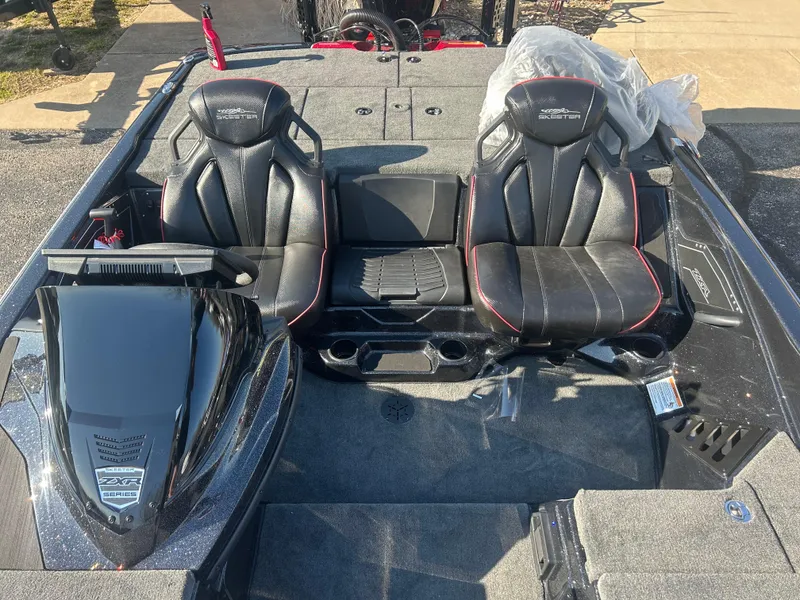 Slide: The Image of 2025 Skeeter ZXR21 boat interior with black leather seats and modern dashboard. - 7