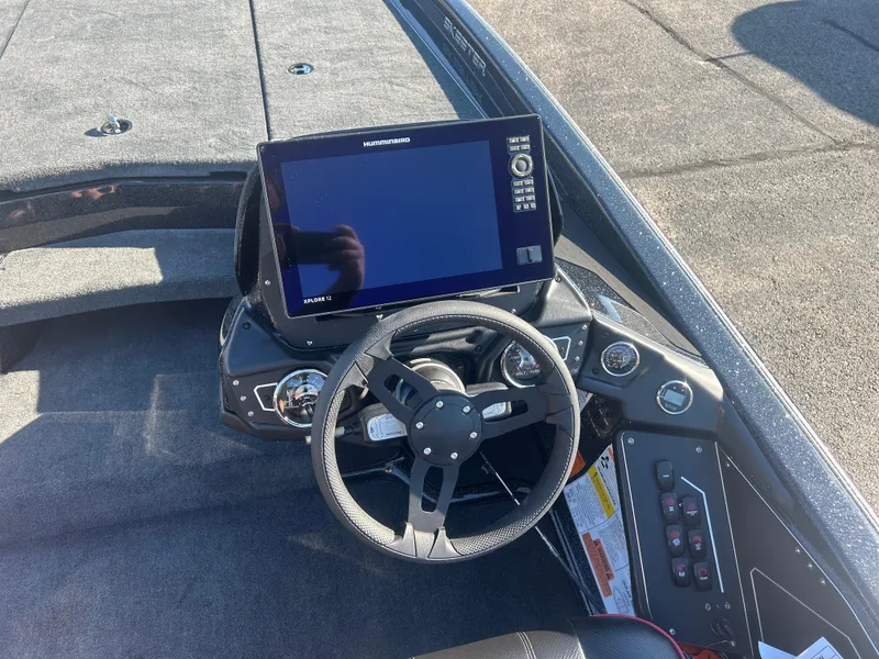 Slide: The Image of 2025 Skeeter ZXR21 boat dashboard with steering wheel and electronic display. - 8