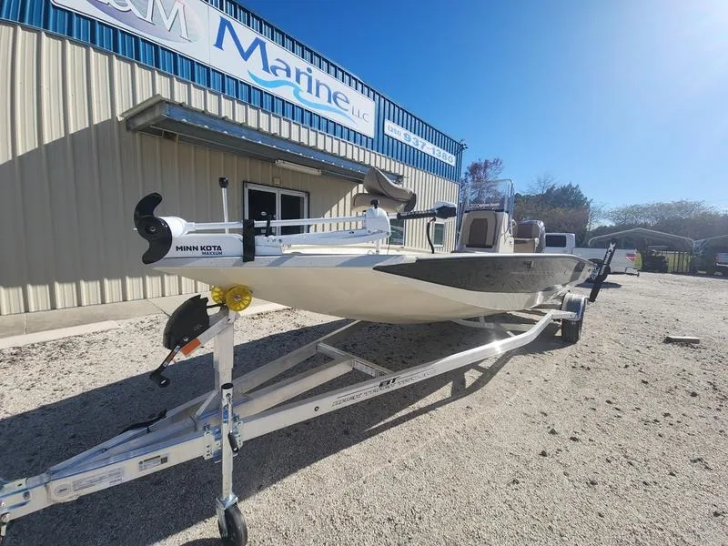 Slide: The Image of 2025 Xpress H22B boat on trailer outside marine dealership. - 1