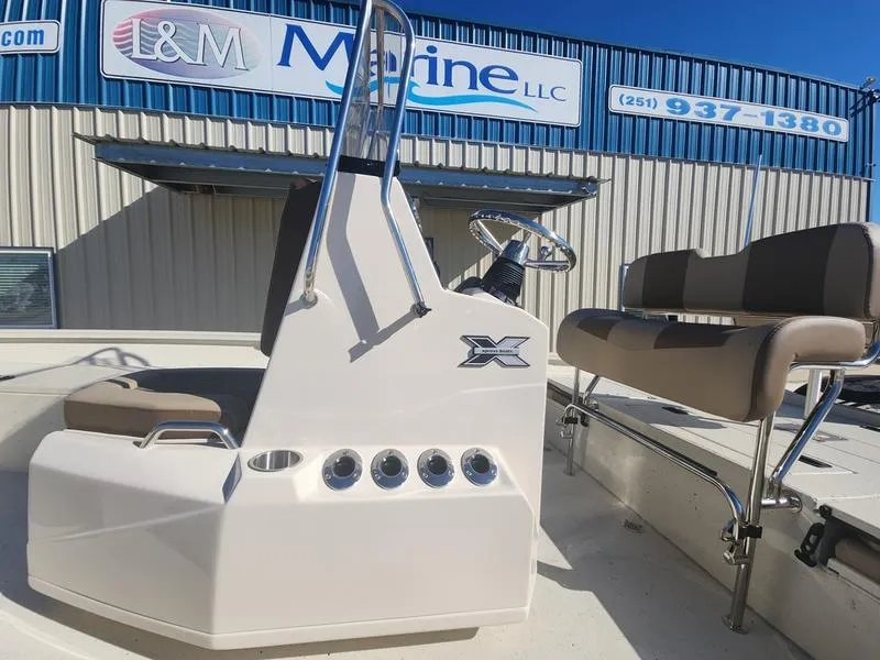 Slide: The Image of 2025 Xpress H22B boat console and seating at L&M Marine dealership. - 11
